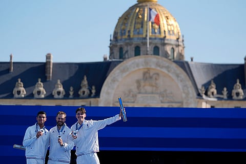 Archery men's team medal ceremony: Silver medal winners, France's Baptiste Addis, left, Thomas Chirault, center and Jean-Charles Valladont